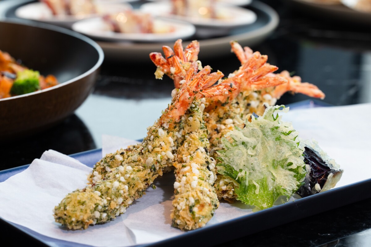 「饗饗」春季新菜〈米菓蝦天婦羅〉以古早味米香替換常見的麵衣，將米香打碎後與麵粉、海苔粉及鰹魚香鬆拌勻，裹住鮮蝦後酥炸。